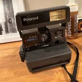 Polaroid camera, Panasonic camera, tanning foam, eyeliner, adapter, Minolta camera, headphones, tennis balls, women's bag 3