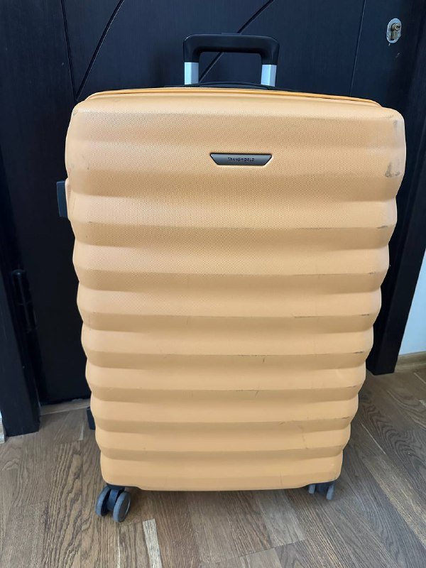 Большой желтый пластиковый чемодан