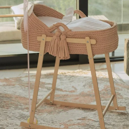 Knitted cradle on a wooden stand
