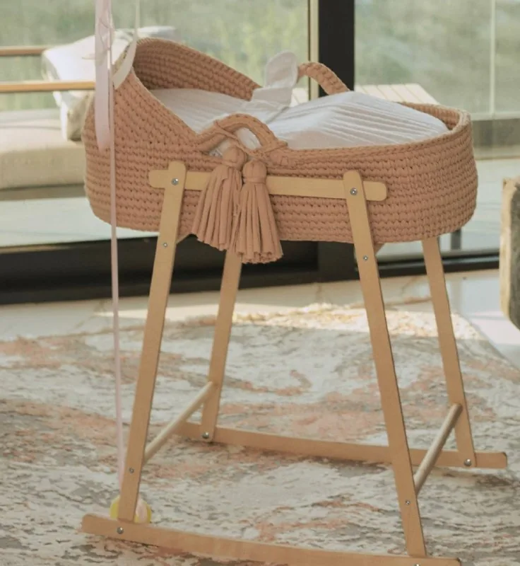 Knitted cradle on a wooden stand