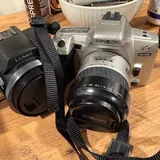 Polaroid camera, Panasonic camera, tanning foam, eyeliner, adapter, Minolta camera, headphones, tennis balls, women's bag 6