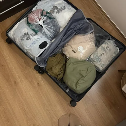 Suitcase of unworn women's clothing and shoes