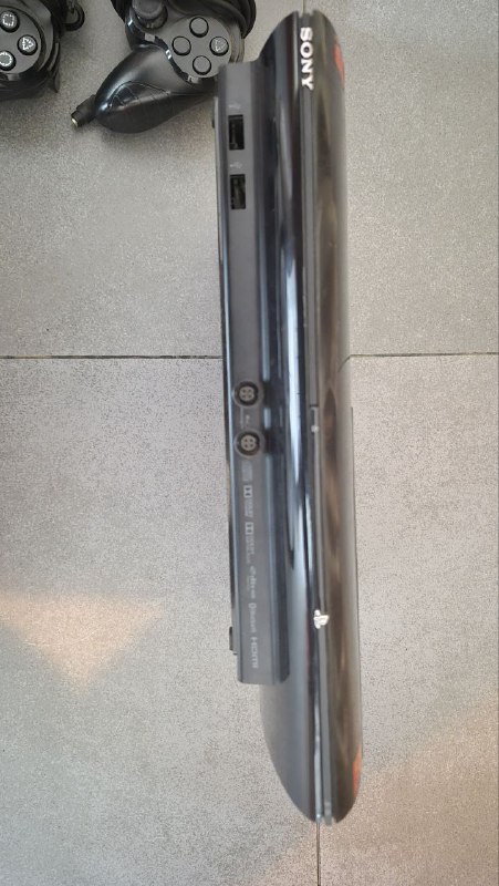 PlayStation 3 Super Slim with games and controllers 2