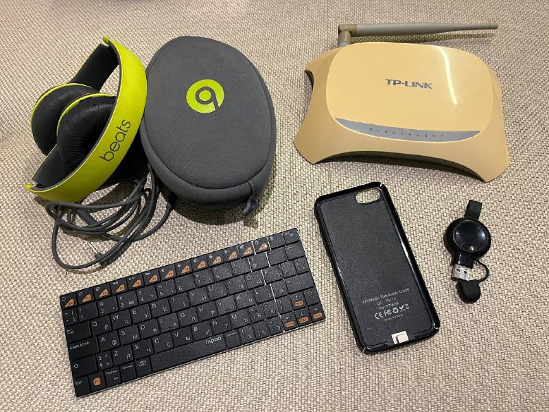 Beats headphones, WiFi router, iPhone case, Apple Watch charger, mini keyboard