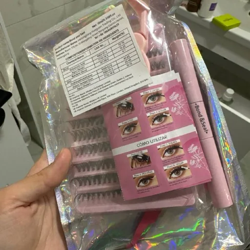 False eyelashes with tweezers, glue and eyelash curler