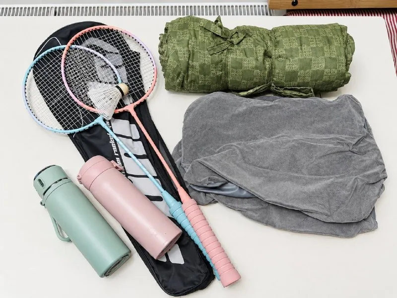 Picnic blanket, inflatable pillows, badminton, bottles